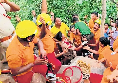 Fire service personnel erupt in joy after rescuing the boy.