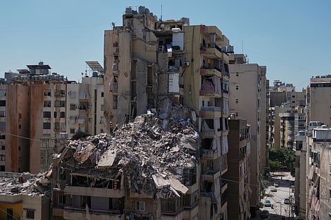 Rescue workers search through the rubble of a building destroyed in an Israeli airstrike the previous day in Dahiyeh, Beirut's southern suburbs, Lebanon, Thursday, May 7, 2026. 
