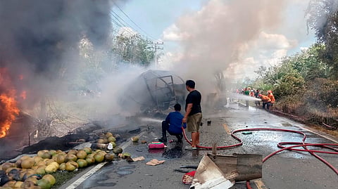 Rescuers try to extinguish a fire after a passenger bus collided with a fuel truck in Musi Rawas, South Sumatra, Indonesia, Wednesday, May 6, 2026.