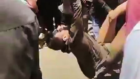 Screengrab of the incident where people beat up Soumya Ranjan Swain following an allegations molestation of girl at Balianta. 