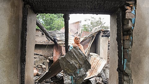 In this photo from May 8, 2025, a resident removes the debris after shelling from Pakistan in a broader village following India’s ‘Operation Sindoor’, at Uri in Baramulla. 