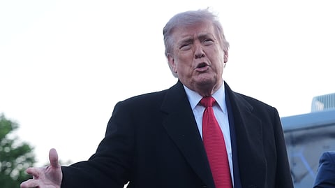 US President Donald Trump speaks as he visits the Lincoln Memorial Reflecting Pool to see the new blue protective coating being applied as part of a renovation project, Thursday, May 7, 2026, in Washington.