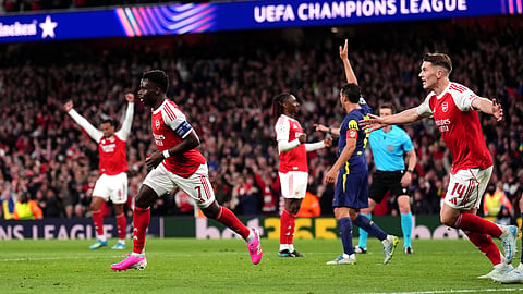 Arsenal's Bukayo Saka, left, celebrates after scoring the opening goal during a Champions League semifinal, second leg, soccer match between Arsenal and Atletico Madrid in London, Tuesday, May 5, 2026. 