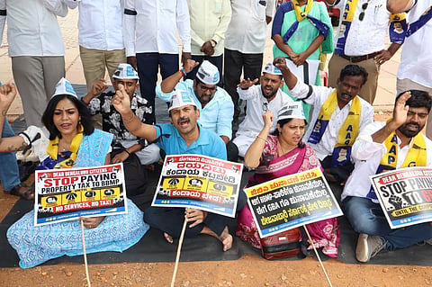 Aam Aadmi Party members protest demanding the government hold GBA polls, at Freedom Park on Friday.