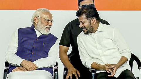 In a screengrab from a video posted on May 10, 2026, Prime Minister Narendra Modi, left, interacts with Telangana Chief Minister A Revanth Reddy during a public meeting, in Hyderabad, Telangana. 