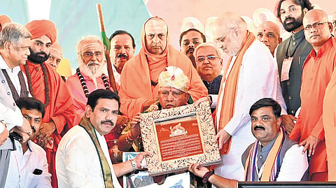 Union Home Minister Amit Shah felicitates former CM BS Yediyurappa during the BSY Abhimanotsava held at 
Shri Madara Chennaiah Guru Peetha in Chitradurga on Saturday.