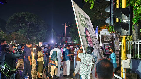 Congress workers removing the flex boards at Vellayambalam Junction near the KPCC office in Thiruvananthapuram, following the address by senior leaders to the media in Delhi on Saturday night.