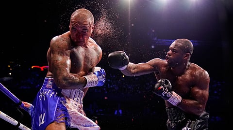 Britain's Daniel Dubois, right, lands a blow on Britain's Fabio Wardley during their WBO World Heavyweight boxing title bout in Manchester, Saturday, May 9, 2026. 