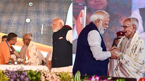 PM Modi greets senior BJP worker Makhanlal Sarkar at Brigade Parade Ground in Kolkata on Saturday.