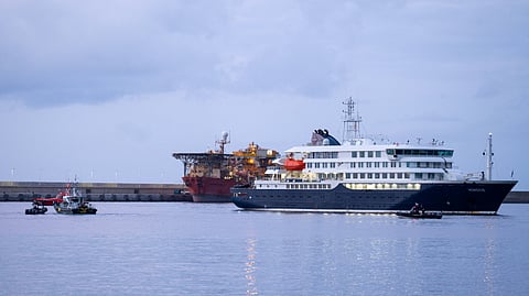 The Dutch flagged hantavirus-stricken cruise ship MV Hondius arrives to the industrial port of Granadilla de Abona on the island of Tenerife in Spain's Canary Islands to commence evacuation of passengers and most crew members on May 10, 2026.