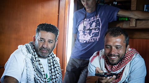 Saif Abukeshek, a Palestinian-Spanish activist and member of the Global Sumud Flotilla’s steering committee, left, and Thiago Ávila, a Brazilian activist and member of the Global Sumud Flotilla’s steering committee, aboard the Greenpeace vessel Arctic Sunrise, which joined a Gaza-bound flotilla in the Mediterranean Sea on April 18, 2026. 