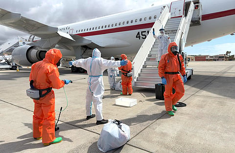 A Spanish passenger is sprayed with disinfectant by Spanish government officials before boarding a plane after disembarking from the hantavirus-stricken cruise ship MV Hondius at Tenerife airport in the Canary Islands, Spain, Sunday, May 10, 2026. 