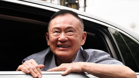 Thailand's former prime minister Thaksin Shinawatra looks on as he arrives at his residency in a car after his release from Klong Prem Central Prison in Bangkok on May 11, 2026.