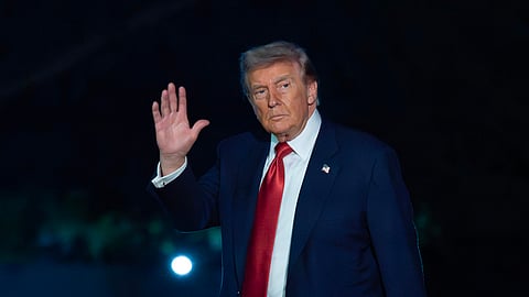 President Donald Trump waves to reporters as he walks on the South Lawn upon his arrival to the White House, Friday, May 8, 2026, in Washington.