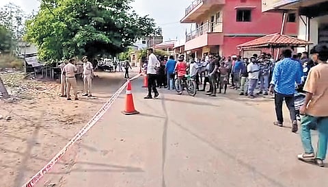 Police and locals at the crime scene in Gandhi Nagar area on Monday.