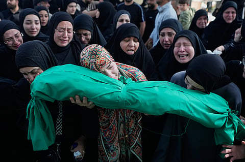 Women grieve as they carry the body of 6-month-old Mariam Fahos during a funeral procession for people killed a day earlier in an Israeli airstrike in the village of Saksakieh, in the southern port city of Sidon, Lebanon, Sunday, May 10, 2026. 