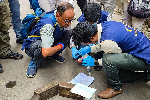 Criminal Investigation Department (CID) officials investigate the crime scene following the killing of BJP leader Suvendu Adhikari's close aide Chandranath Rath, at Madhyamgram, in North 24 Parganas district, West Bengal, Thursday, May 7, 2026.