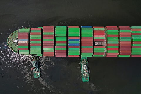 Tugboats assist a container ship as it prepares to dock at the Manila International Container Terminal at the Philippine capital, April 8, 2025.