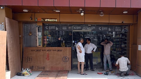 Shop owners in Delhis New Ashok Nagar are shutting their shops ahead of the the sealing drive scheduled for Tuesday. The shops were running commercial businesses in residential areas.