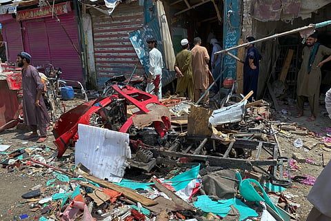Local residents examine damage at the site of a bomb explosion at a market in Sarai Norag in Lakki Marwat, a district in Pakistan’s Khyber Pakhtunkhwa province, Tuesday, May 12, 2026.
