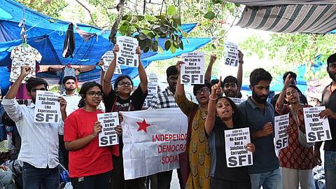 SFI members and supporters stage a protest against the alleged NEET 2026 scam in New Delhi on May 12, 2026.