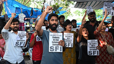 SFI members and supporters stage a protest against the alleged NEET 2026 scam in New Delhi on May 12, 2026.