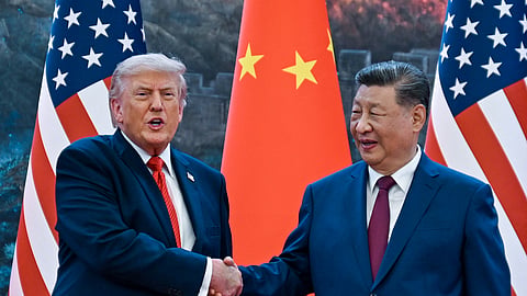 US President Donald Trump (R) shakes hands with China's President Xi Jinping at the Great Hall of the People in Beijing on May 14, 2026.