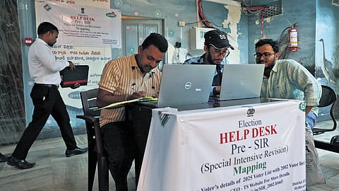 GHMC employees man a help desk set up at the corporation's head office for pre-SIR mapping of voter details in Hyderabad on Wednesday.