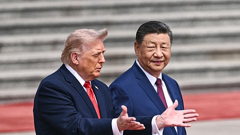US President Donald Trump (L) takes part in a welcome ceremony with China's President Xi Jinping at the Great Hall of the People in Beijing on May 14, 2026.