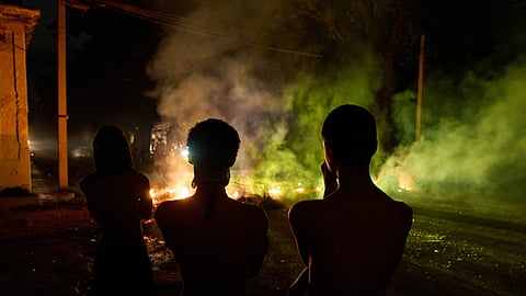 People look at a barricade set up by residents protesting against prolonged power outages in Havana, Cuba, on Wednesday, May 13, 2026. 