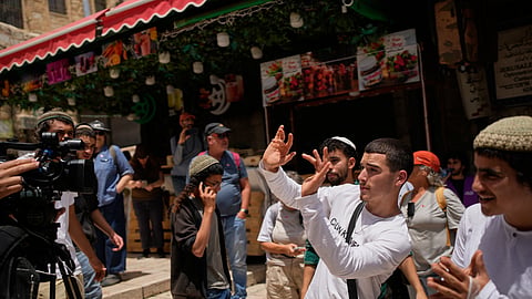 A youth gestures toward a camera as Israeli youths gather in Jerusalem's Old City before a march marking Jerusalem Day, an Israeli holiday celebrating the capture of east Jerusalem in the 1967 Mideast war, in Jerusalem, Thursday, May 14, 2026.