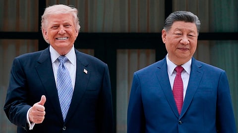 U.S. President Donald Trump, left, poses for a picture with Chinese President Xi Jinping during a visit to the Zhongnanhai Garden in Beijing, Friday, May 15, 2026.