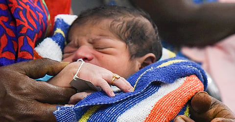  A newborn baby with gold ring. 