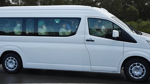 Passengers from the hantavirus-stricken cruise ship MV Hondius are driven in a bus after they arrived in Perth, Australia, from the Netherlands on Friday, May 15, 2026.