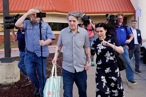 Former death row prisoner Richard Glossip, center, exits a detention facility alongside his wife Lea Glossip after being granted bond while awaiting retrial Thursday, May 14, 2026, in Oklahoma City. 