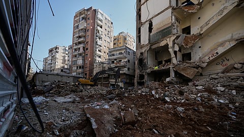 A bulldozer clears the rubble where a sports clothing shop was destroyed in a previous Israeli airstrike in Chiyah, a southern Beirut suburb, May 6, 2026.