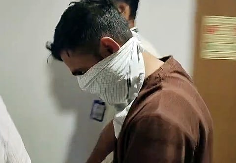  An accused, Dhananjay Lokhande, in the alleged NEET-UG 2026 paper leak, being taken from the Rouse Avenue Court after the court grants a six-day custody of the accused to the CBI, in New Delhi on Friday. 