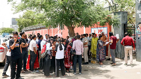 In this photo from May 3, 2026, aspirants stand outside the exam centre to appear for the National Eligibility cum Entrance Test Undergraduate (NEET UG) exam in Jaipur. 