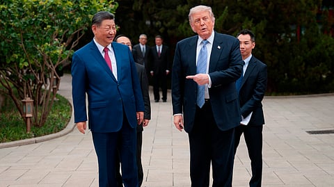 U.S. President Donald Trump gestures towards Chinese President Xi Jinping while leaving after a visit to the Zhongnanhai Garden in Beijing, Friday, May 15, 2026. 