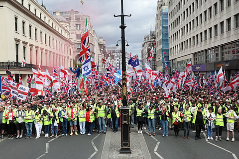 Supporters of British far-right activist Tommy Robinson, real name Stephen Yaxley-Lennon, take part in a march organised by 'Unite The Kingdom' in central London on May 16, 2026.
