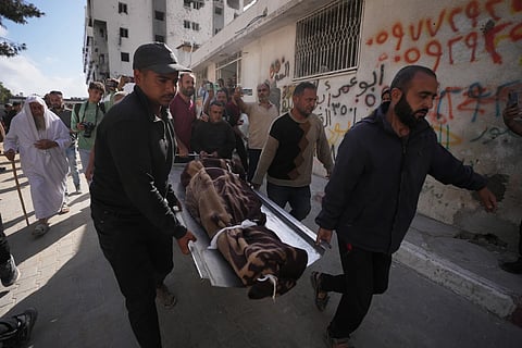 Palestinians carry the body of a person killed in Israeli airstrikes Friday targeting Izz al-Din al-Haddad , the leader of Hamas' Qassam Brigades during a funeral outside Shifa hospital in Gaza City, Saturday, May 16, 2026. 