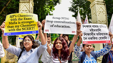  SFI members stage a protest against the National Testing Agency (NTA) over the alleged paper leak concerns following the cancellation of the NEET-UG 2026 examination, at Cotton University, in Guwahati, Assam, Saturday, May 16, 2026.
