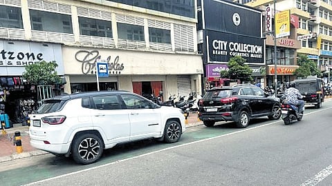 Despite ‘no parking’ signs, four-wheelers occupy a cycling lane