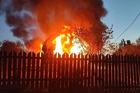 A burning building following an air attack at an undisclosed location in the Moscow region, amid the ongoing Russian-Ukrainian conflict.