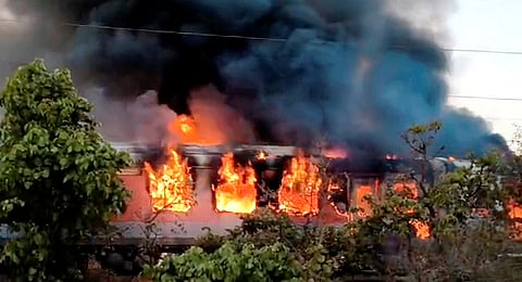 Flames and smoke billow after a fire broke out in an AC coach of the Thiruvananthapuram-Hazrat Nizamuddin Rajdhani Express in Madhya Pradesh's Ratlam district, Sunday, May 17, 2026. 