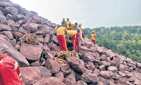Rescue personnel retrieving the operator’s body from the mine