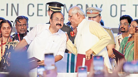Governor Rajendra Arlekar has a word with CM-designate V D Satheesan before the swearing-in ceremony at Central Stadium.