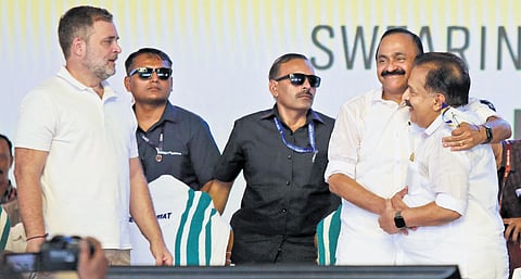 Chief Minister V D Satheesan and cabinet colleague Ramesh Chennithala greet each other during the swearing-in of the new UDF government, as Congress leader Rahul Gandhi looks on, at Central Stadium in Thiruvananthapuram on Monday.