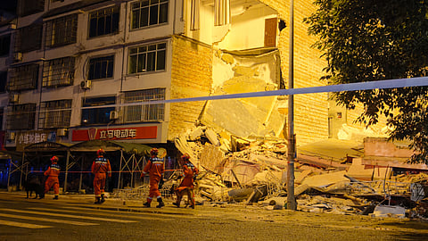 Rescuers walk past a collapsed building after an earthquake in Liuzhou, China's southern Guangxi region on May 18, 2026.
A 5.2-magnitude earthquake struck south China's Guangxi region on May 18, killing two people and causing 13 buildings to collapse, state media reported.