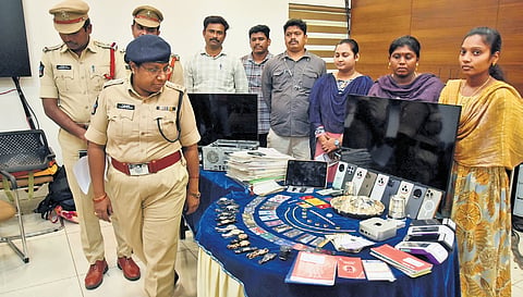 Vijayawada Cybercrime DCP K Krishna Prasanna takes a look at the gadgets used in `5.28 crore loan scam during a press conference on Monday.